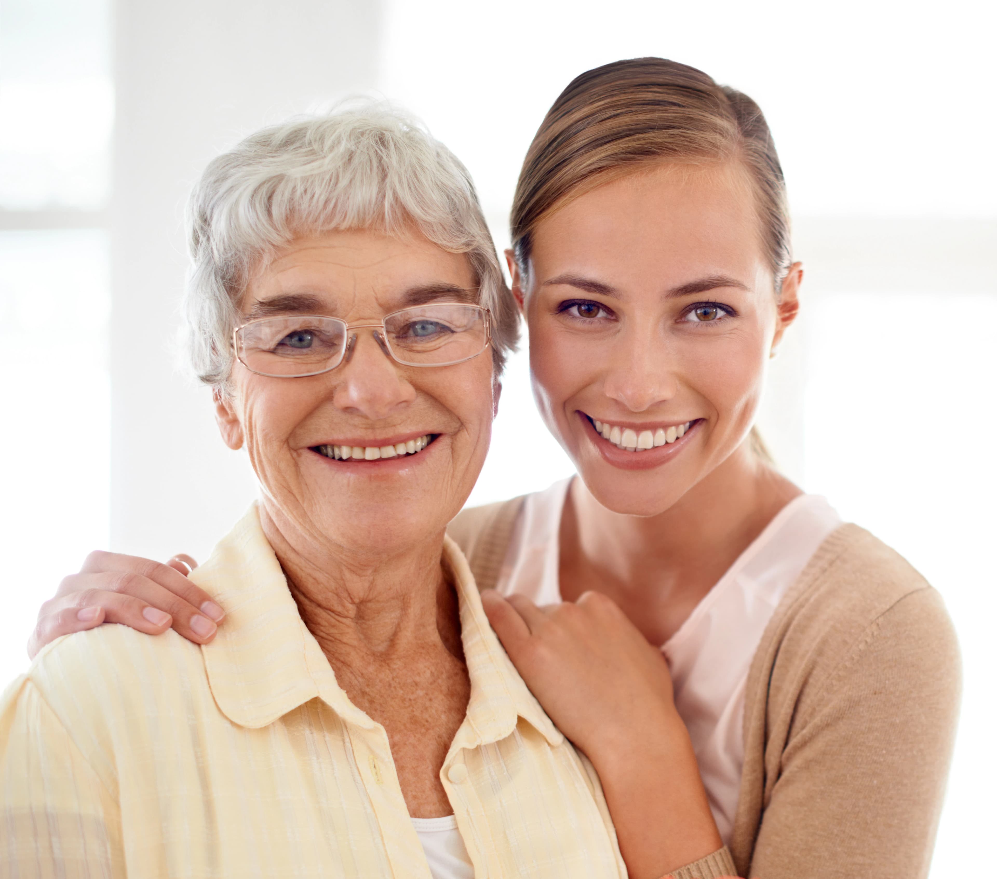 A family member shares a warm, unhurried moment at home with their elderly loved one.